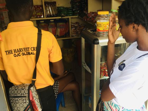 A crew member reaching traders where they work